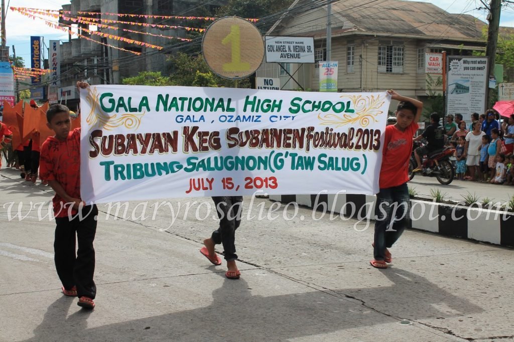 two boys showcasing Gala National High School banner for tourism in Misamis Occidental