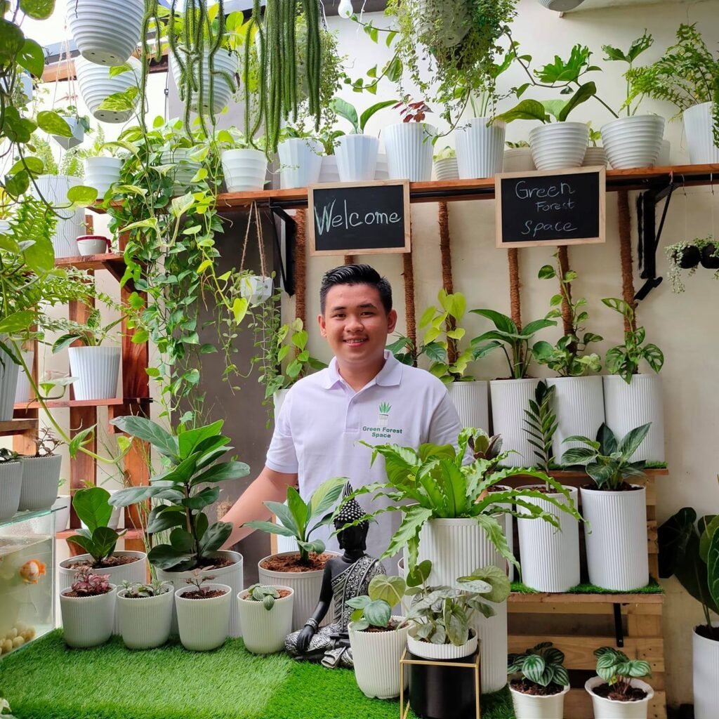 boy standing with his posh plants in white pots and Misamis Occidental healthy food