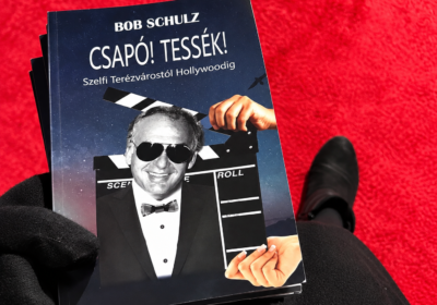 Bob Schulz’s autobiography, Csapó! Tessék!, featuring his portrait on the cover, photographed on a red carpet during his memorial tribute in Toronto.