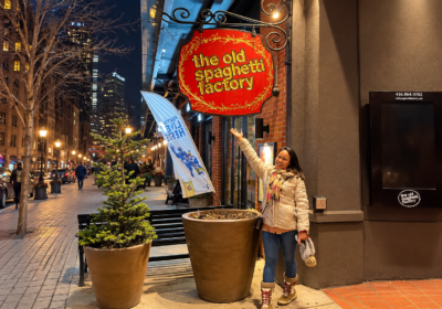 Woman Smiling Beneath the Old Spaghetti Factory Toronto Sign