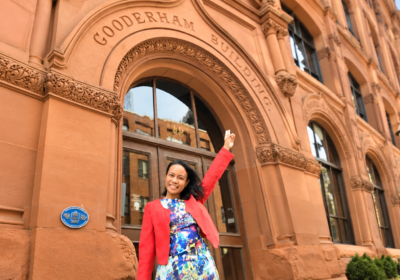 Single woman exploring Old Town Toronto on foot at the historic Gooderham Building