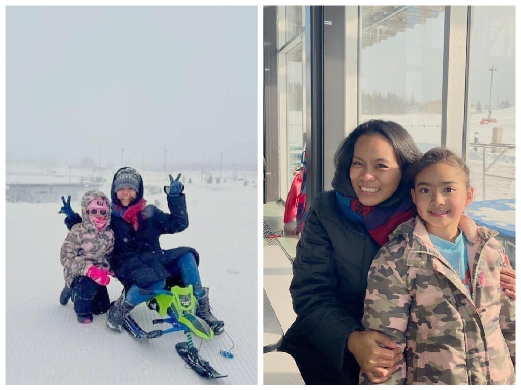 female adult and child doing winter sports