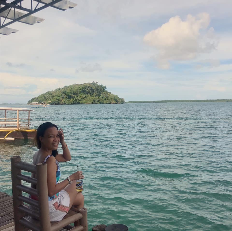 girl enjoying a bottle of beer in the beach in Misamis Occidental