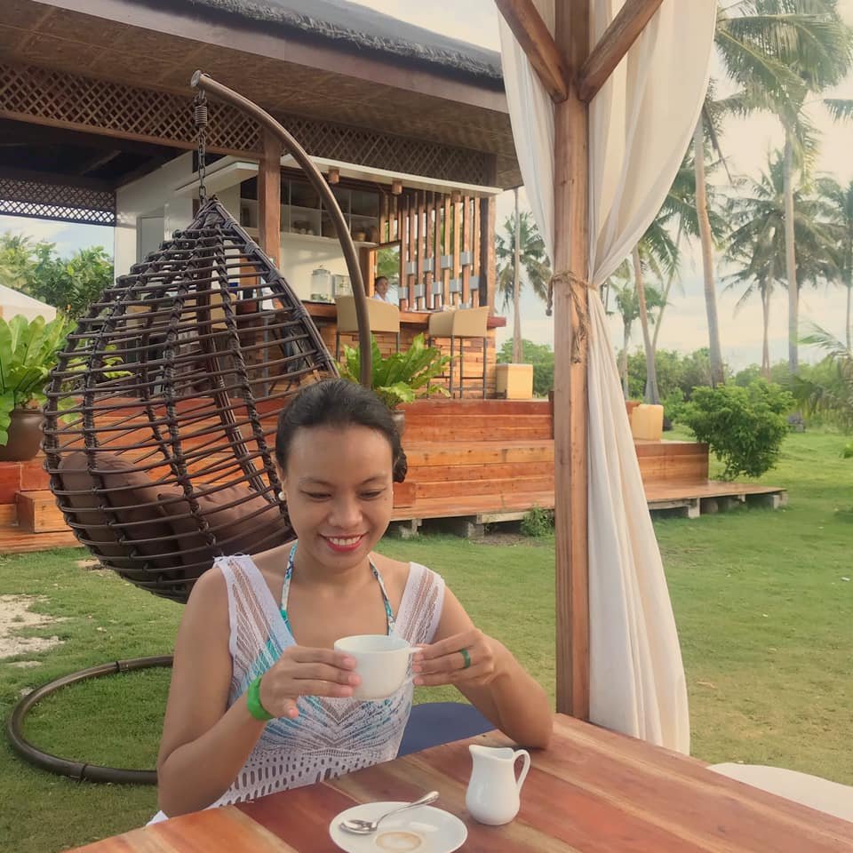 girl having coffee in the beach in Misamis Occidental