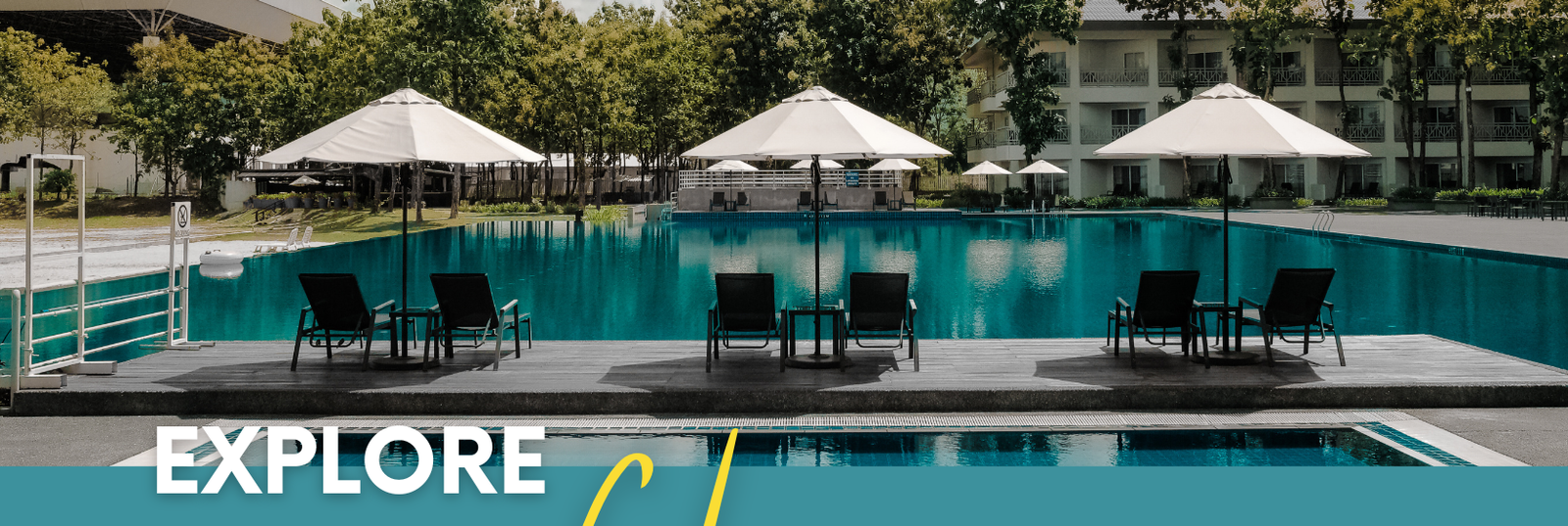 swimming pool with poolside tables, chairs, and umbrellas