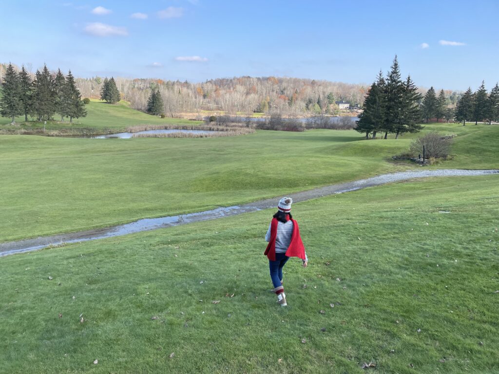 Woman walking across a peaceful green landscape in Ontario